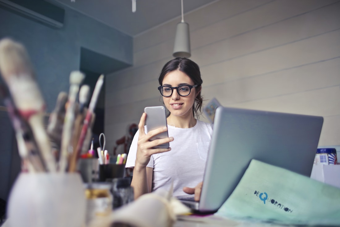 Woman in a white shirt using a smartphone